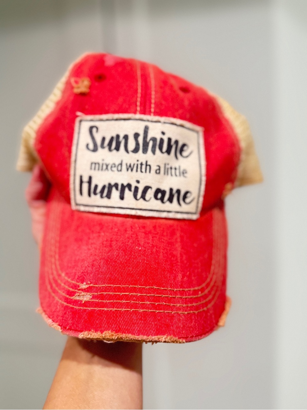 Red Trucker Hat with 'Sunshine mixed with a little Hurricane' Patch
